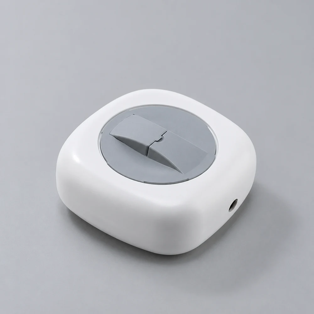 White and gray rotatable cable storage box in a neutral studio, AI-assisted illustrative image